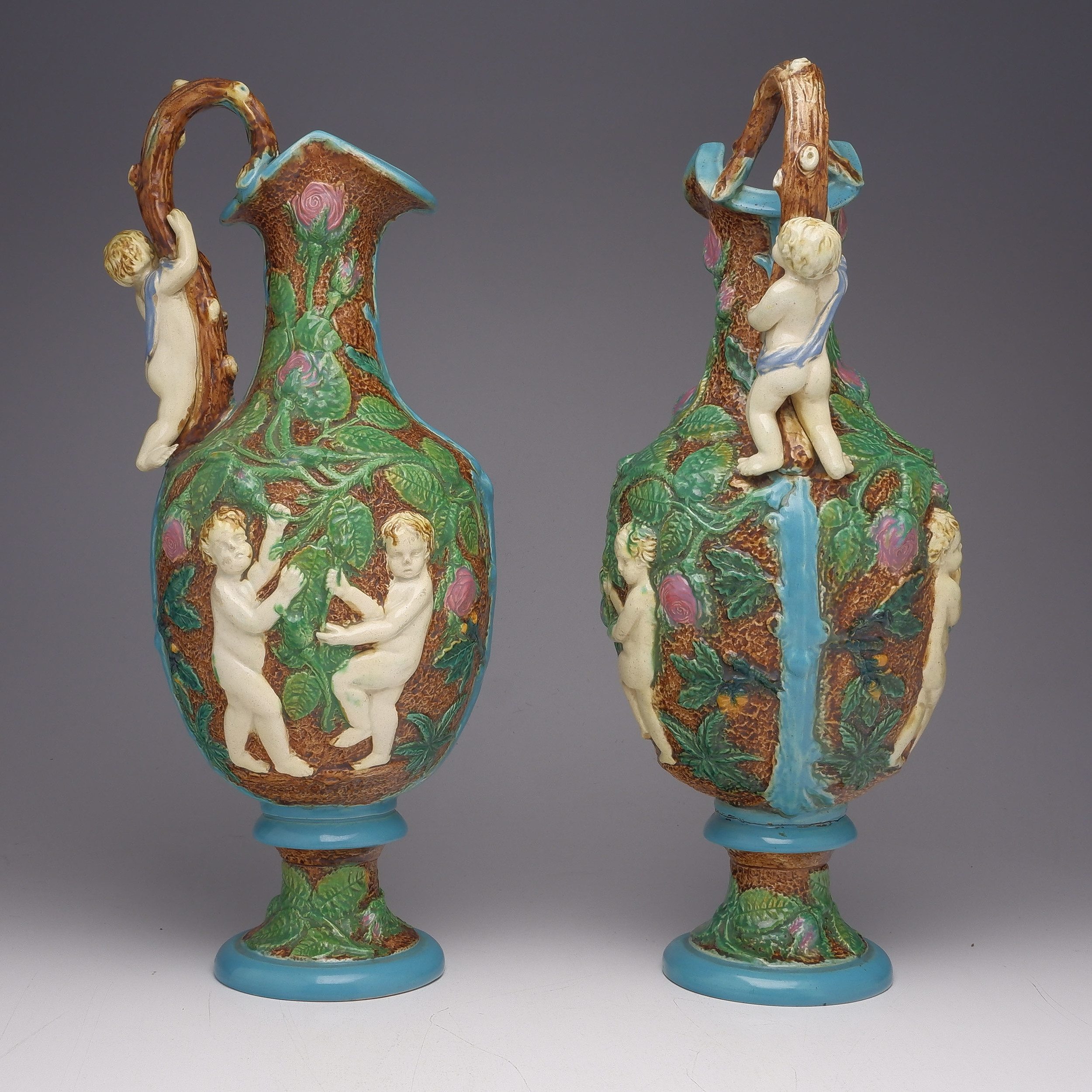 'Fine Pair of Large Victorian Majolica Ewers Moulded with Putti, England Circa 1880, Probably William Brownfield'