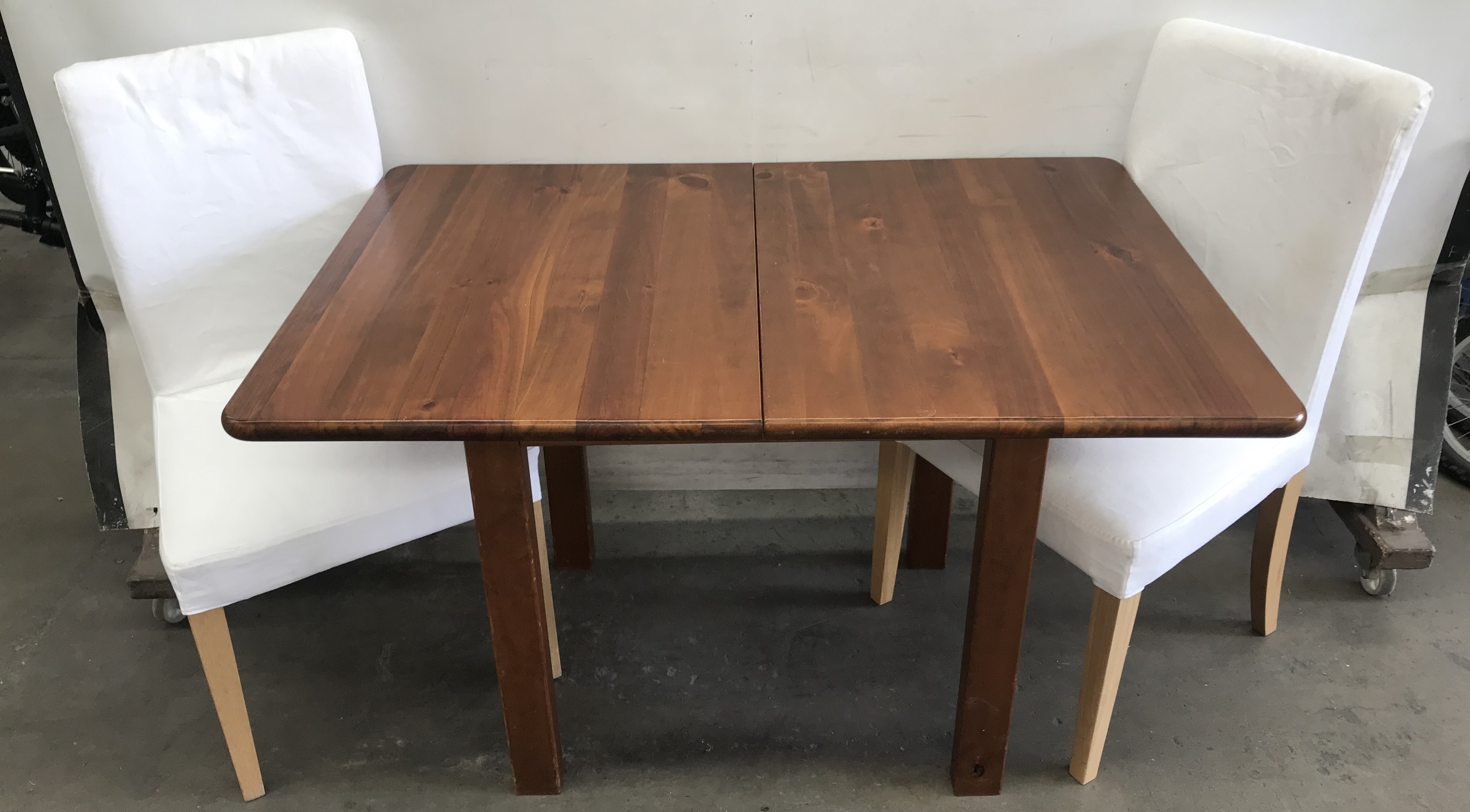 pine table and two chairs