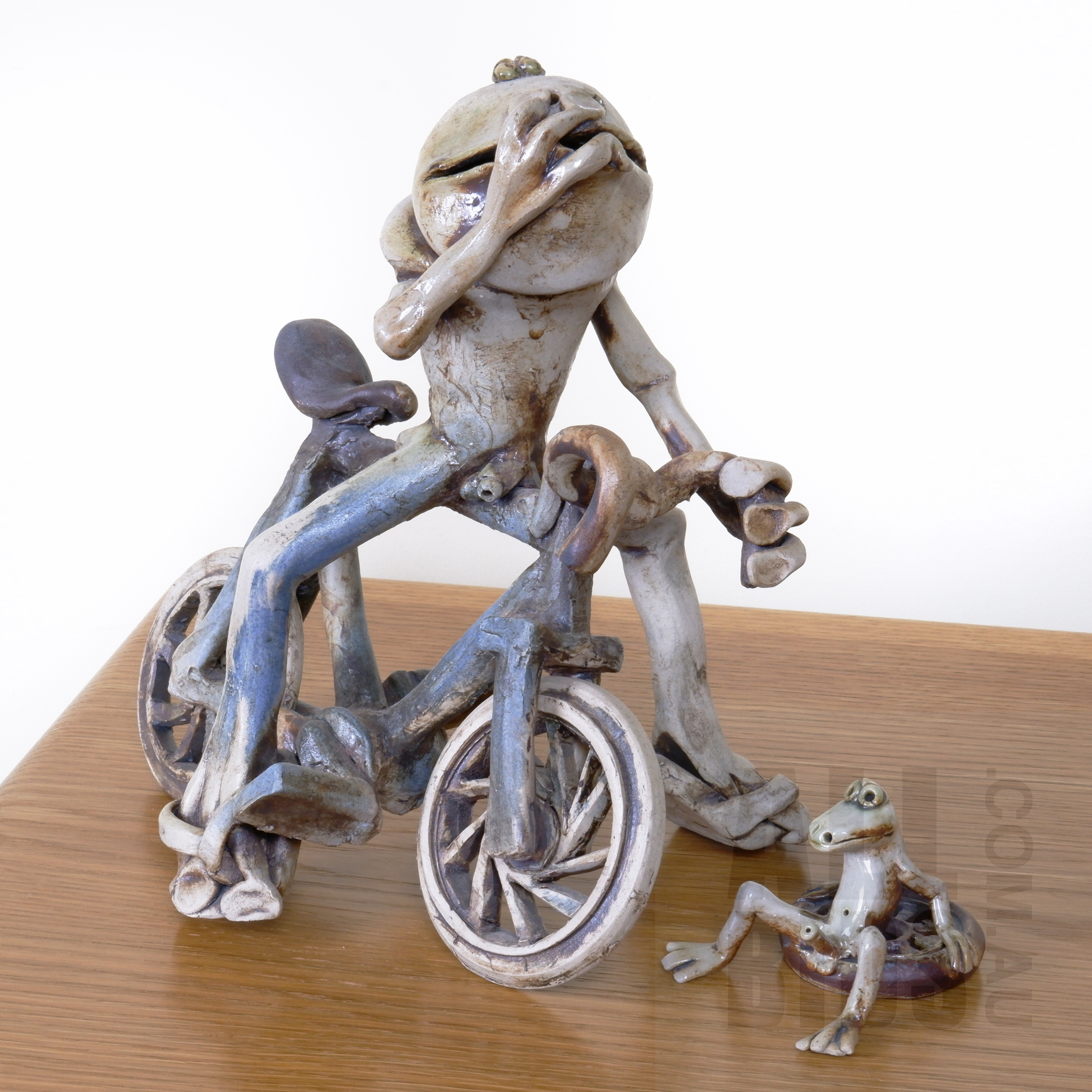'Australian School Ceramic Sculpture of Frog Riding a Bicycle and Another Sitting on a Tire'