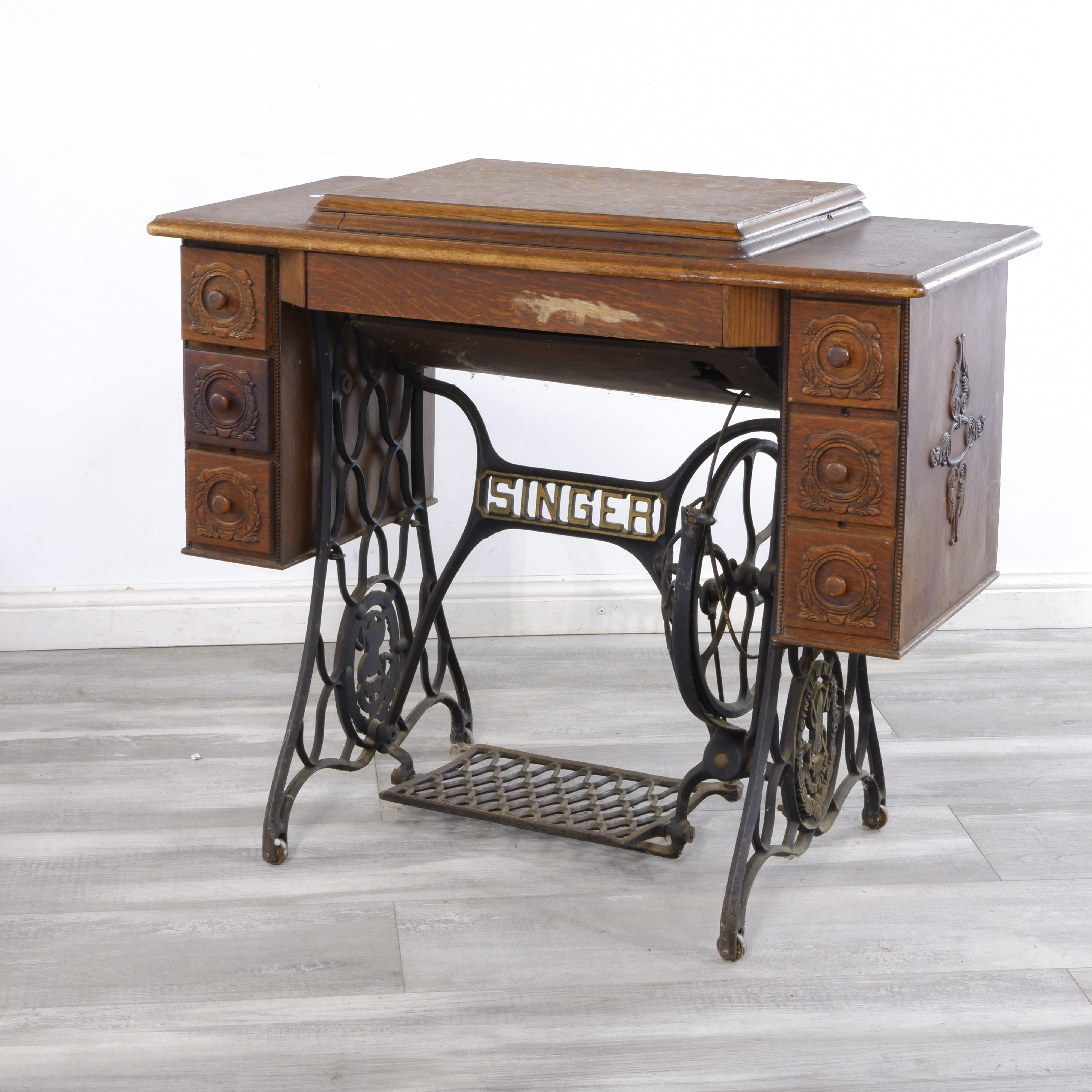 antique singer sewing machine in oak cabinet